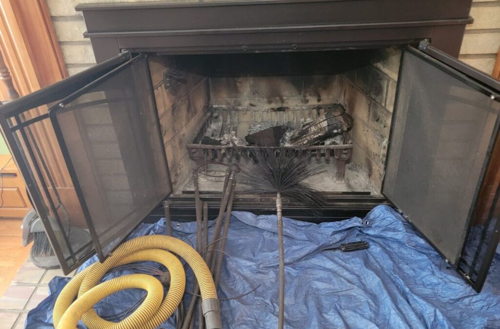 A technician from Green and Clean Home Services performing chimney cleaning in Bainbridge, OH, improving heating efficiency.
